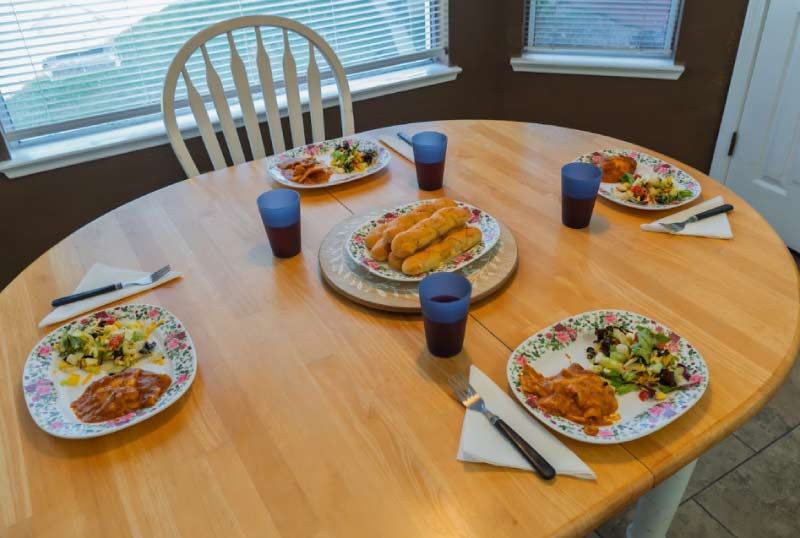 A beautifully set dining table featuring fresh, home-cooked Portuguese-inspired meals for residents. Guardian Angel Home Care prioritizes high-quality nutrition and traditional recipes to ensure seniors feel nurtured and at home.