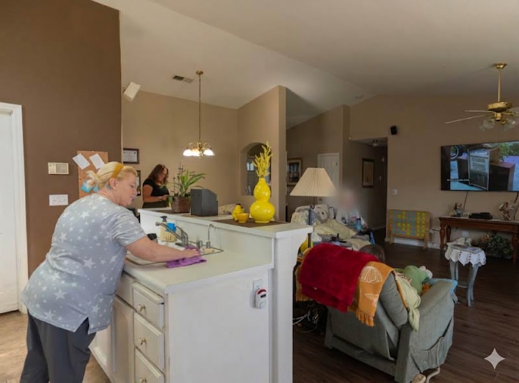 A spacious, sunlit common room at Guardian Angel Home Care featuring a large entertainment center, comfortable reclining chairs, and a sliding glass door leading to the backyard, providing a peaceful social area for senior residents.